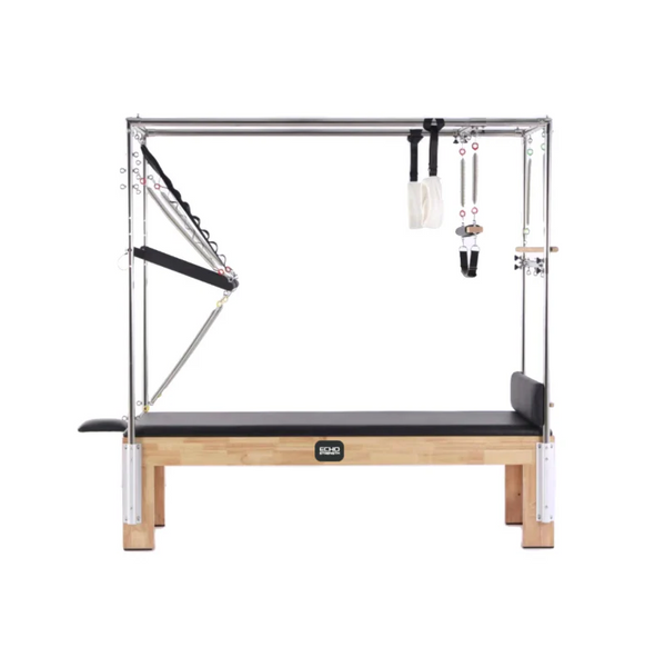 The Echo Kodiak Echo Pilates Cadillac Reformer Vintage features a solid oak frame with metal bars, springs, and straps.