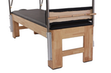 Echo Kodiak Echo Pilates Cadillac Reformer Vintage with black pad, metal frame, viewed from the foot.