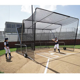 Two players use the Sports Supply Group High School Batting Cage Turtle; one bats while the other watches outside.