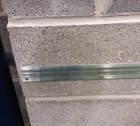 Kodiak Sports Indoor Sports Wood Backed Wall Padding mounts horizontally on concrete walls using two screws.
